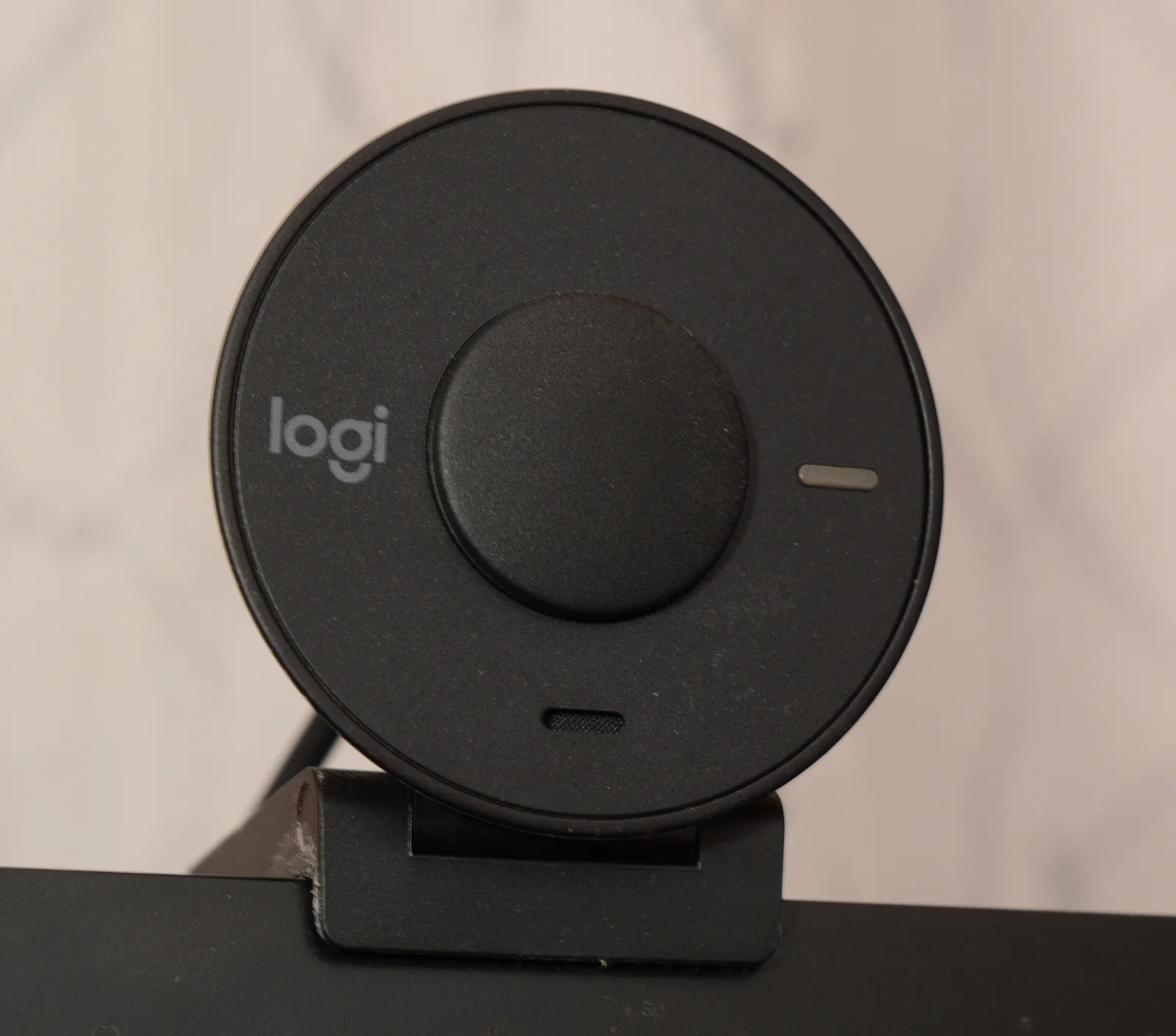 Close-up of a Logitech Brio 301 webcam showing its front face and microphone openings